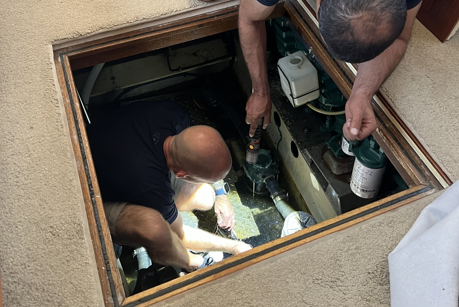 Marine electrician diagnosing a flooded bilge compartment on a powerboat in the San Francisco Bay Area