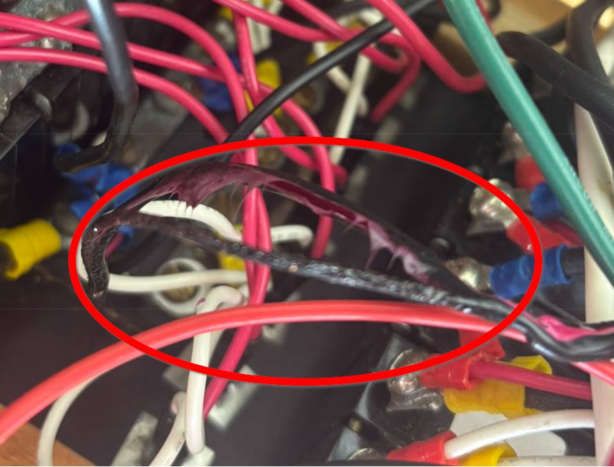 Melted wire insulation on VHF radio power cable caused by resistive heating through wire tie steel core — fire hazard found during marine electrical safety inspection San Francisco Bay Area
